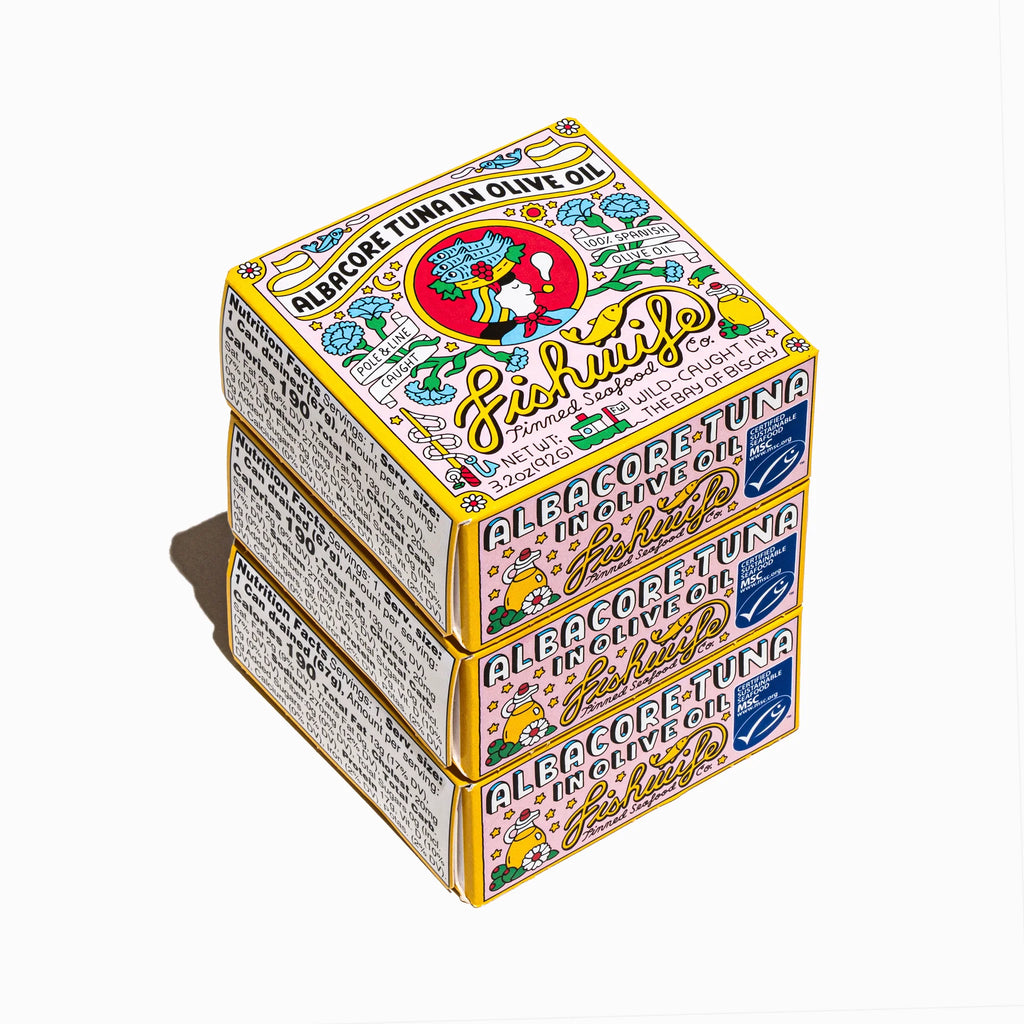 Stacked colorful boxes of Fishwife albacore tuna in olive oil on a white background