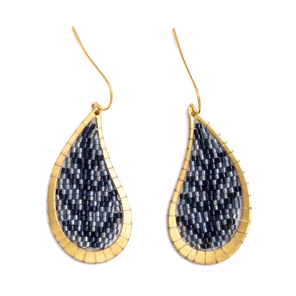 Teardrop-shaped beaded earrings with gold frame and blue and silver bead design on a white background