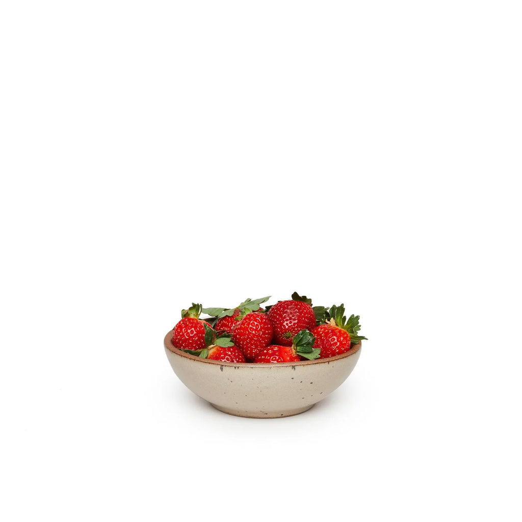 morel colored pottery bowl holding strawberries