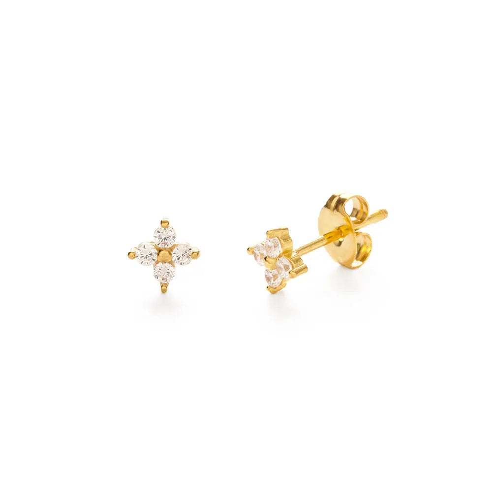 Gold stud earrings with star-shaped gemstones on a white background