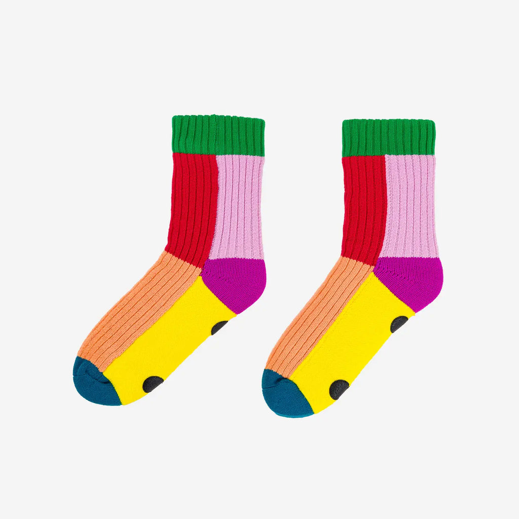 multi-color knitted fleece lined house socks with green, red, lilac, lavender, peach and blue patches. On white background.