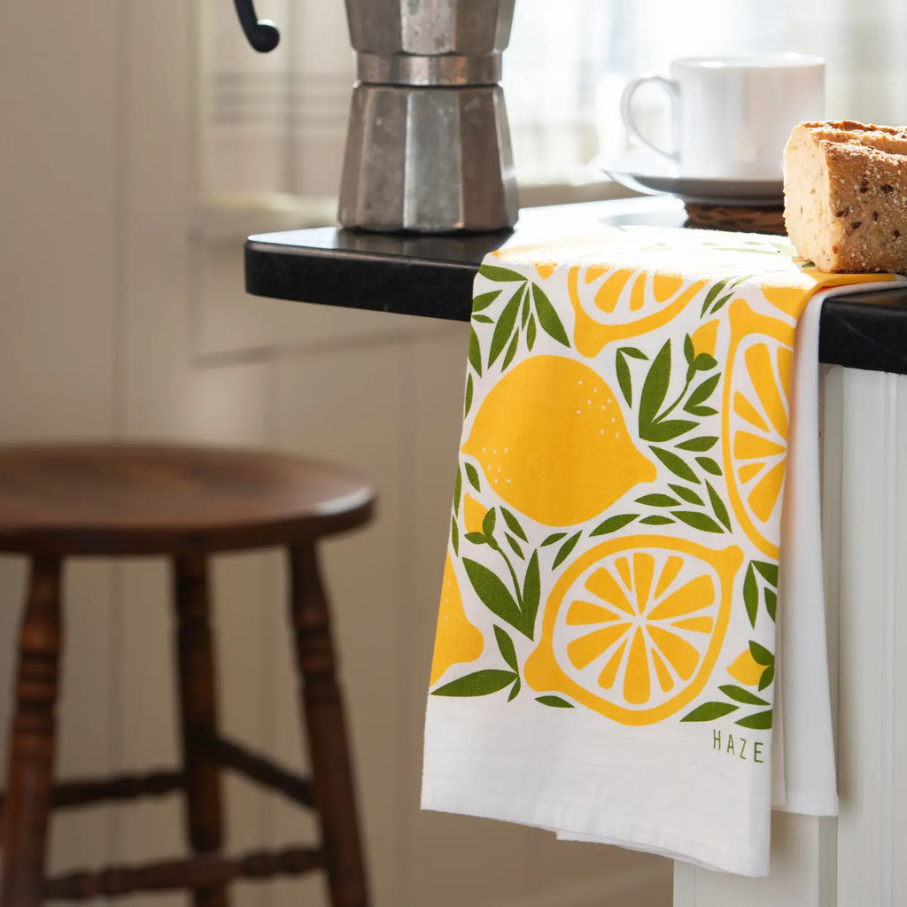 Kitchen towel with lemon design hanging on a kitchen counter