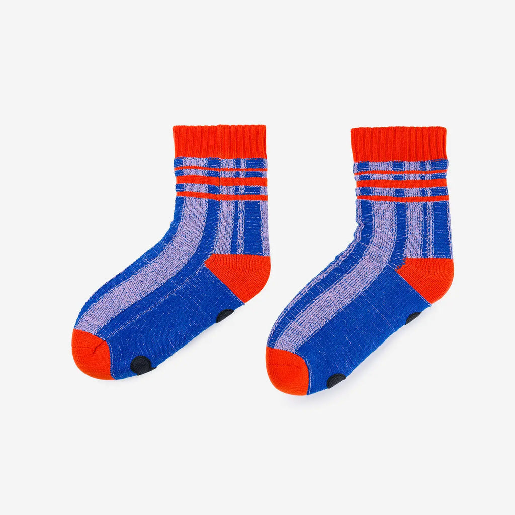 cobalt and lilac striped knitted fleece lined house socks with red banding around top, heel and toe.  white background