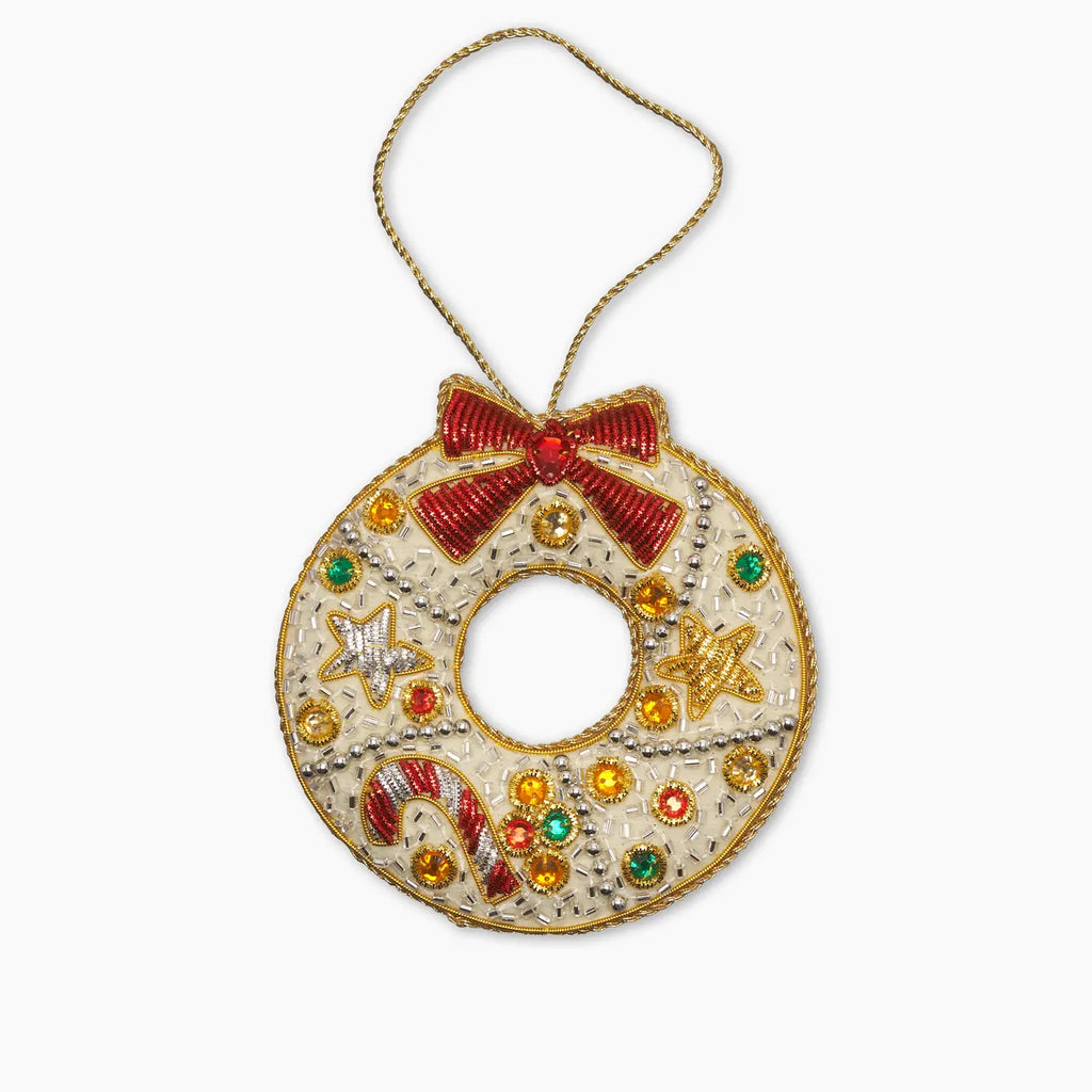 Decorative Christmas wreath ornament with a bow and colorful embellishments on a white background