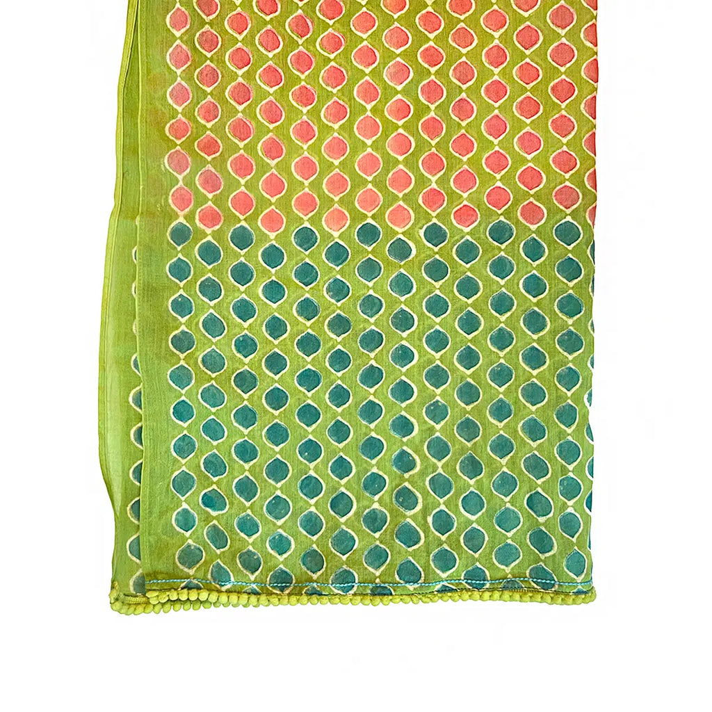 Colorful patterned fabric with pink and green geometric polka dot design on a white background
