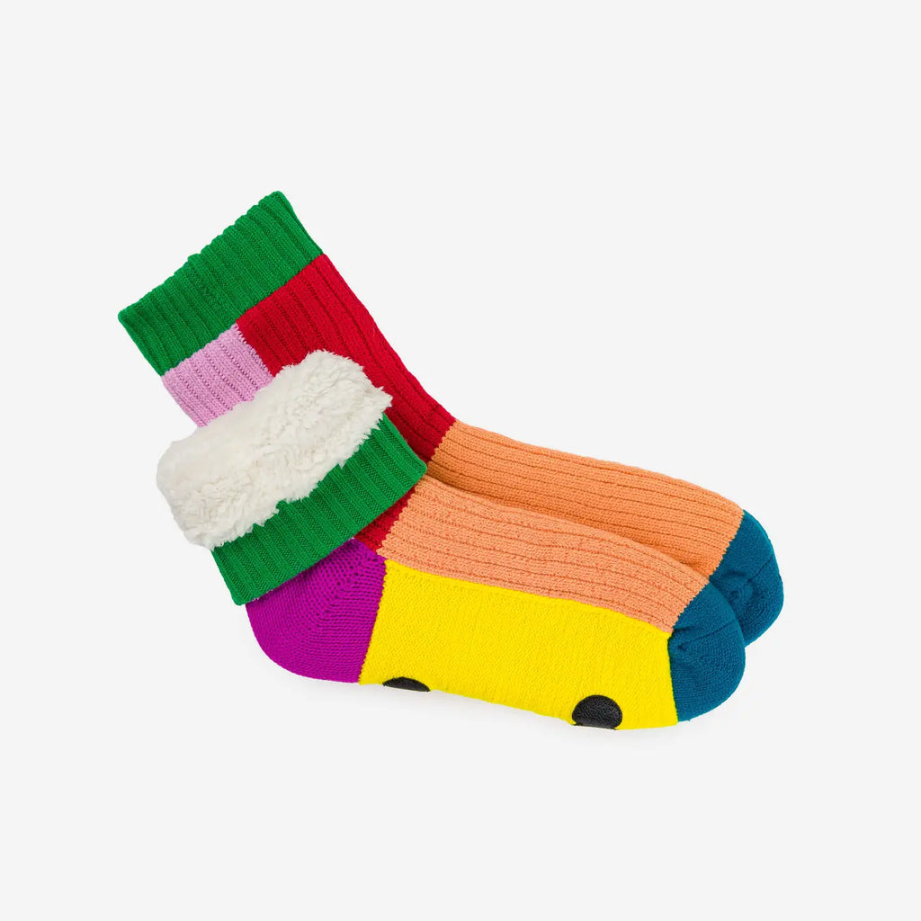 multi-color knitted house socks with green, red, lilac, lavender, peach and blue patches. Showing fleece lining. On white background.