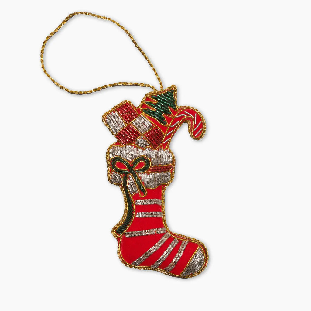 Decorative Christmas stocking ornament with candy cane and bow on a white background