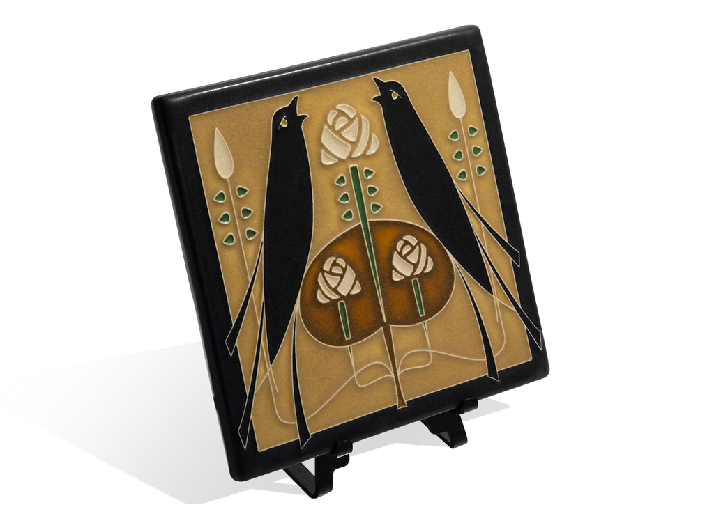 Decorative tile with black birds and roses on a beige background