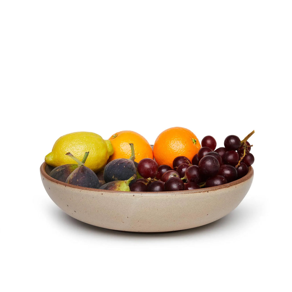 Eastfork pottery weeknight serving bowl in morel color, holding an assortment of colorful fruits