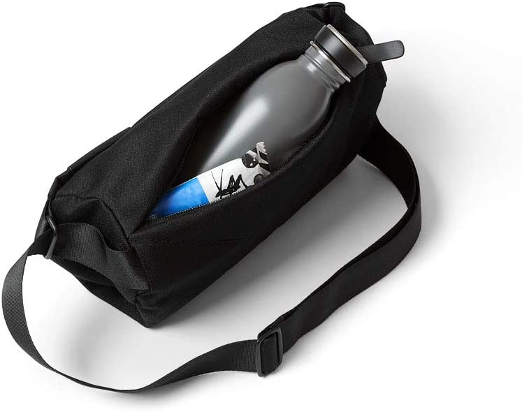 black mini sling bag unzipped with water bottle sticking out