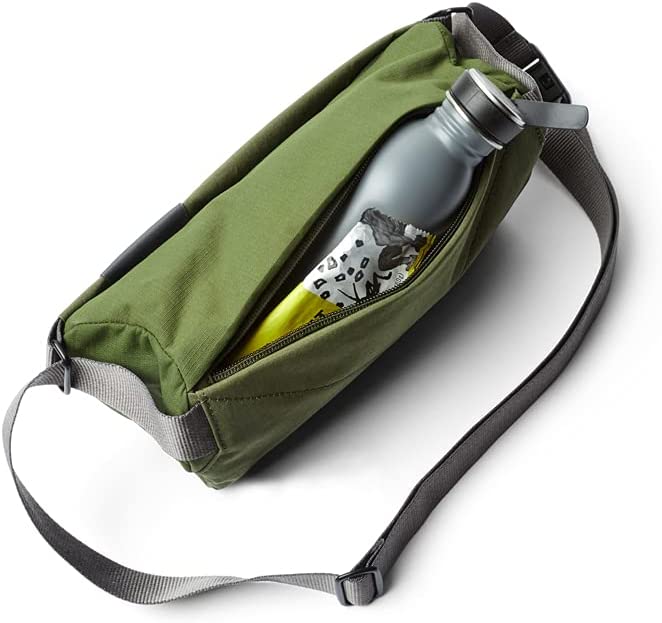 green sling bag unzipped with water bottle sticking out